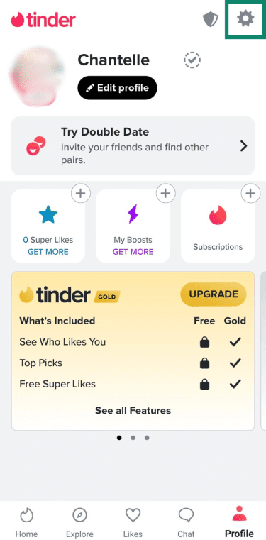 Tinder profile screen with the settings gear icon in the top right corner highlighted in a green box.